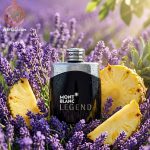 شیشه عطر مونت بلانک لجند در میان گل‌های اسطوخودوس و آناناس تازه